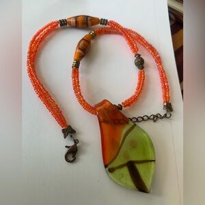 Super vibrant orange glass beaded necklacee with glass pendant 18”